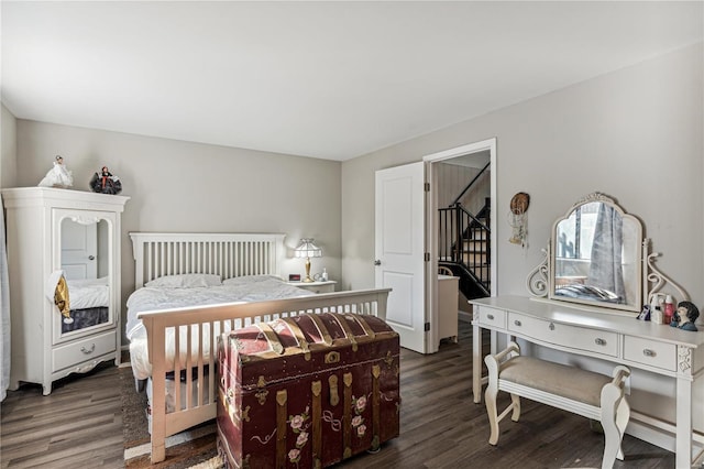 bedroom with dark wood-type flooring