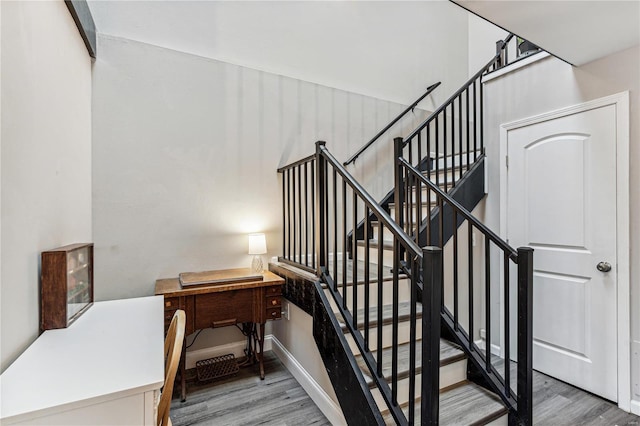 stairway with hardwood / wood-style flooring