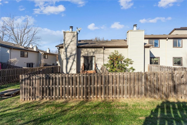 rear view of property featuring a yard