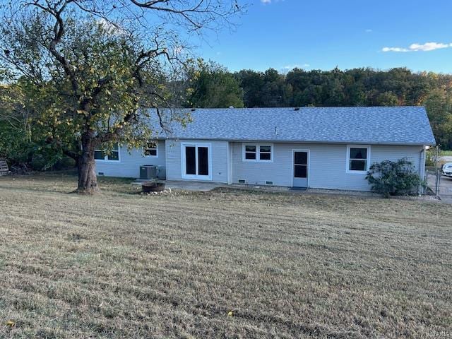 rear view of house featuring a patio area, central AC unit, and a lawn