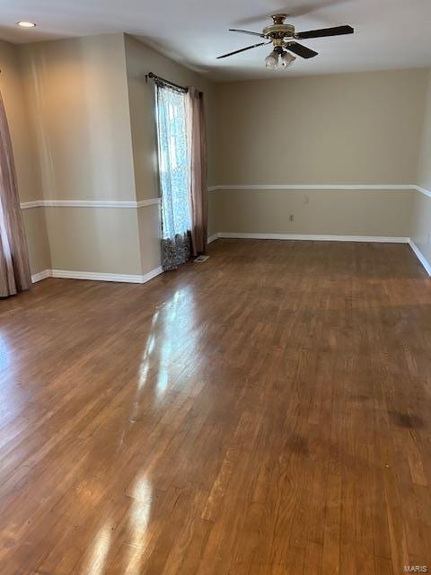 unfurnished room featuring ceiling fan and dark hardwood / wood-style floors