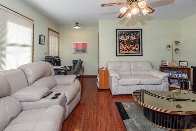 living room featuring ceiling fan, a textured ceiling, and dark hardwood / wood-style floors