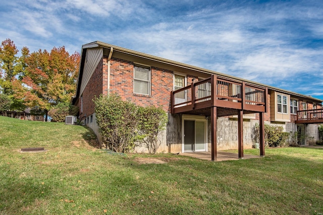 rear view of property with a wooden deck, a yard, and central AC unit