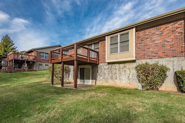 back of property with a yard and a deck