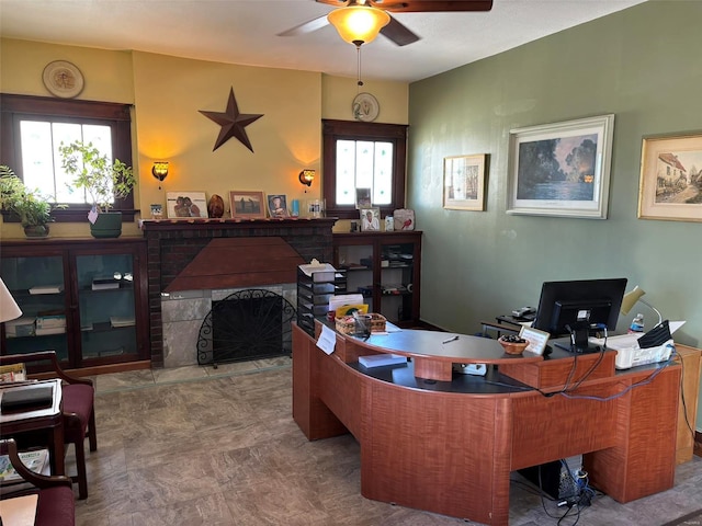 office with a fireplace, ceiling fan, and a wealth of natural light