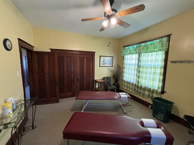 home office with ceiling fan and light colored carpet