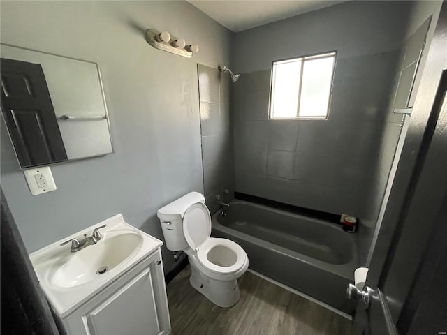 full bathroom featuring vanity, toilet, tiled shower / bath combo, and wood-type flooring