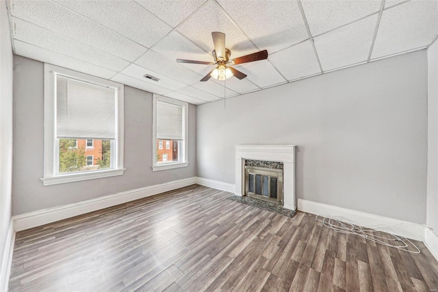 unfurnished living room featuring a paneled ceiling, wood-type flooring, and ceiling fan