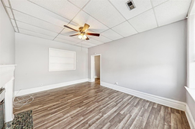 unfurnished living room with ceiling fan, wood-type flooring, and a paneled ceiling