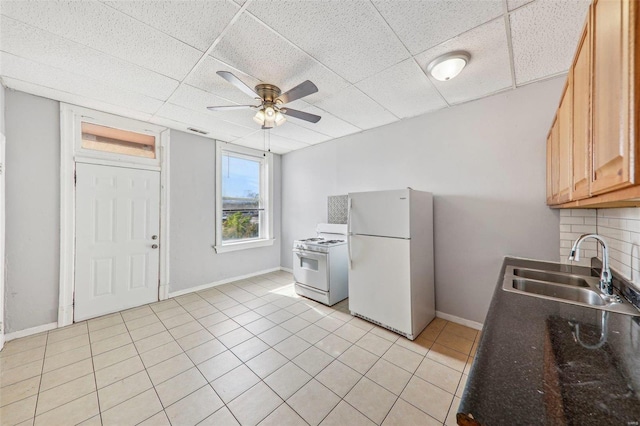 kitchen with sink, a drop ceiling, tasteful backsplash, white appliances, and ceiling fan