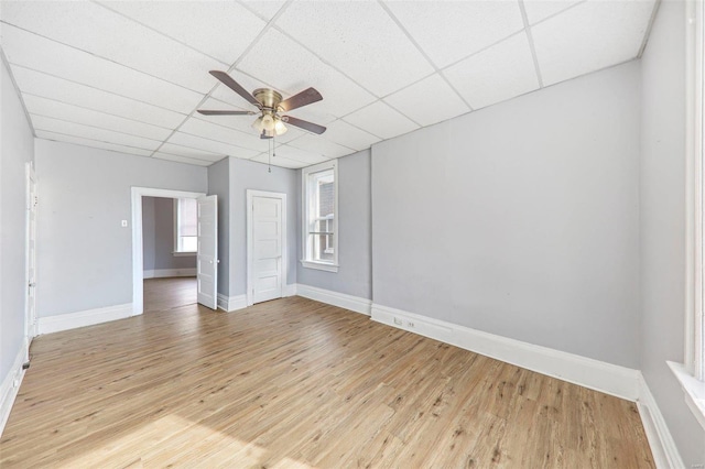 unfurnished room featuring a paneled ceiling, light hardwood / wood-style flooring, and ceiling fan