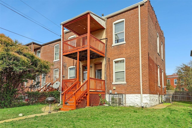 rear view of house with a yard