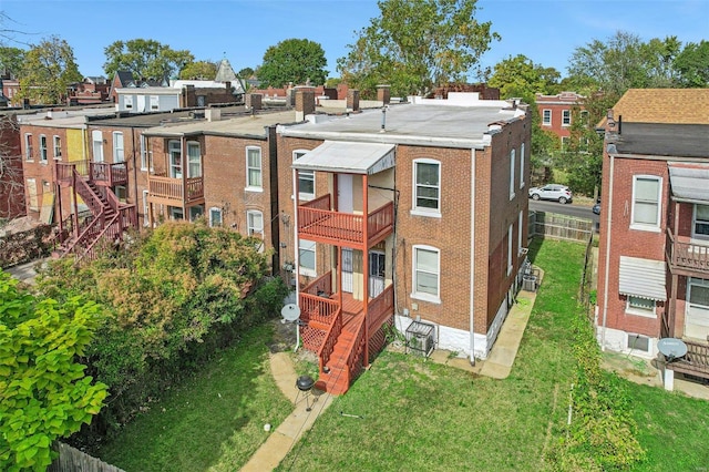 rear view of property featuring a lawn