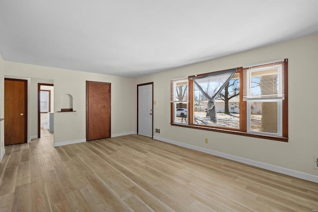 interior space featuring light wood-style flooring and baseboards