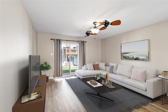 living room with ceiling fan and wood-type flooring