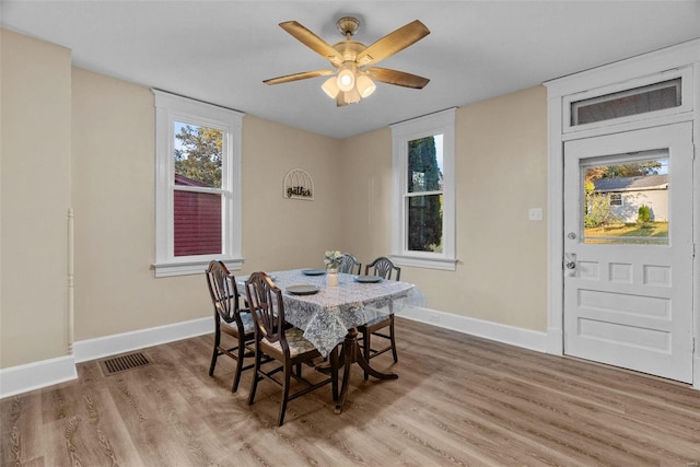 dining space featuring a wealth of natural light, light hardwood / wood-style flooring, and ceiling fan