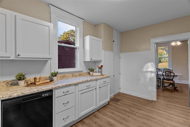 kitchen with white cabinetry, black dishwasher, and a healthy amount of sunlight