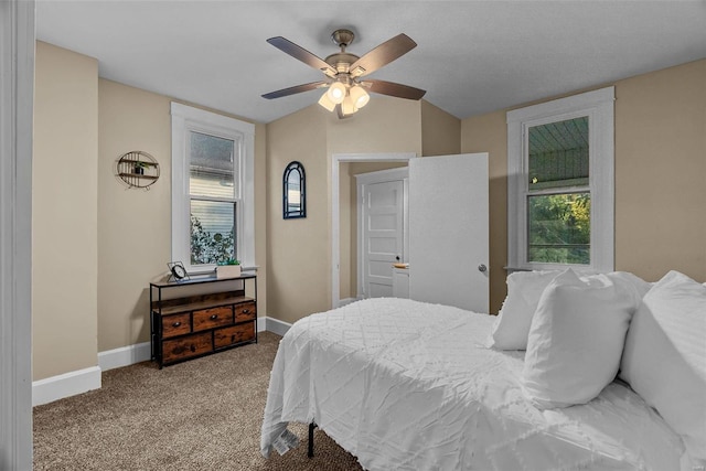 carpeted bedroom with multiple windows and ceiling fan