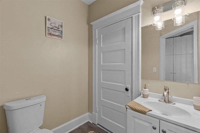 bathroom featuring toilet and vanity