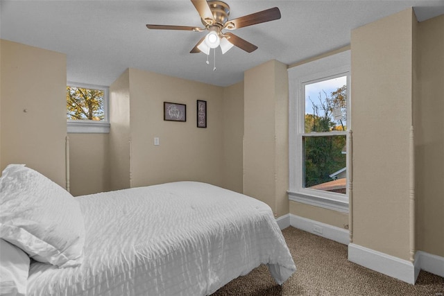 bedroom featuring carpet, multiple windows, and ceiling fan