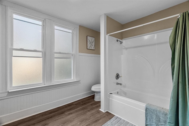 bathroom featuring shower / bath combination with curtain, toilet, and hardwood / wood-style floors