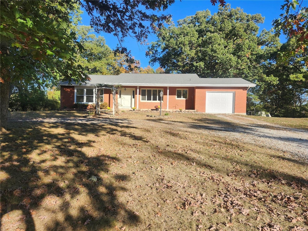 single story home with a front yard and a garage