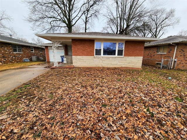 view of front of home featuring a garage and cooling unit