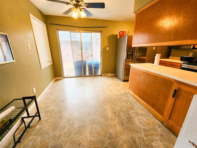 kitchen featuring ceiling fan and stainless steel fridge with ice dispenser