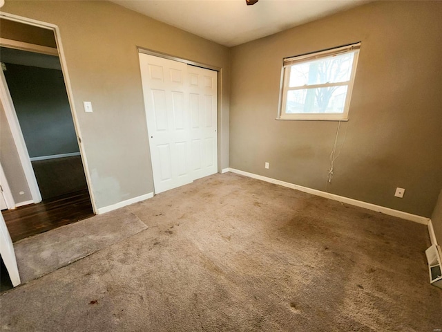 unfurnished bedroom with a closet and carpet