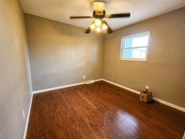 spare room with dark hardwood / wood-style floors and ceiling fan