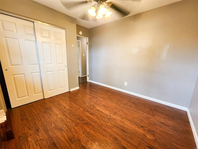 unfurnished bedroom featuring a closet, ceiling fan, and dark wood-type flooring