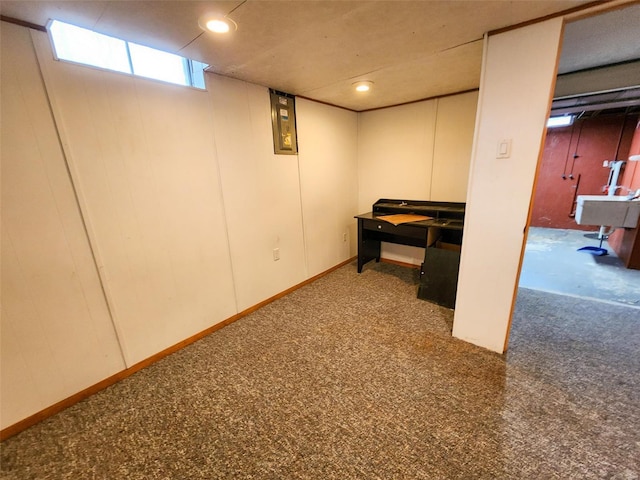 basement with dark colored carpet and sink