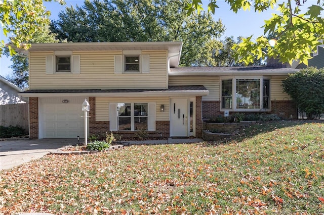 tri-level home with a front yard and a garage