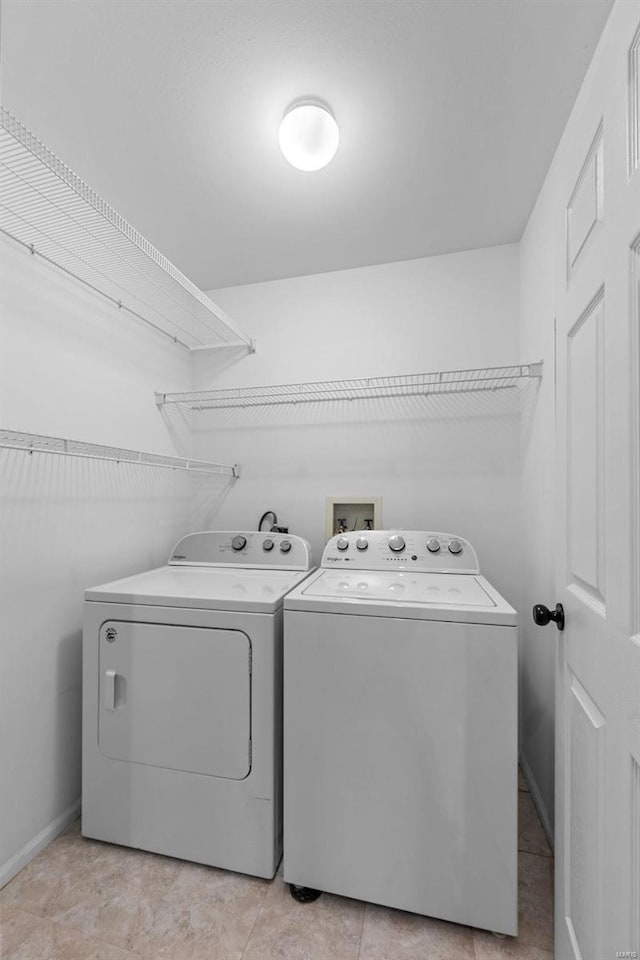 clothes washing area featuring washing machine and clothes dryer