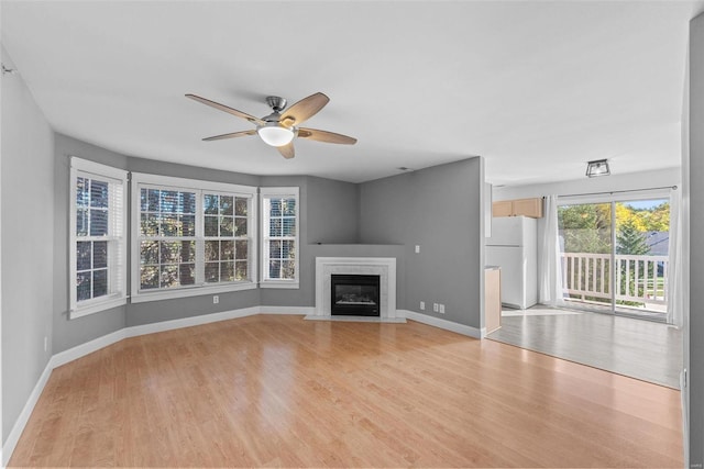 unfurnished living room with light hardwood / wood-style floors and ceiling fan