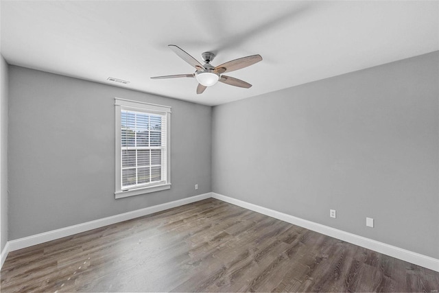 spare room featuring wood-type flooring and ceiling fan