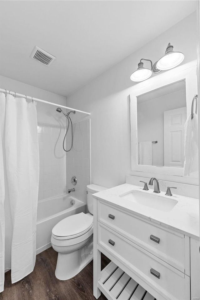 full bathroom featuring vanity, toilet, shower / bath combo with shower curtain, and hardwood / wood-style floors