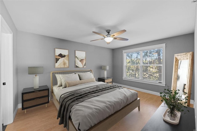 bedroom with light hardwood / wood-style flooring and ceiling fan