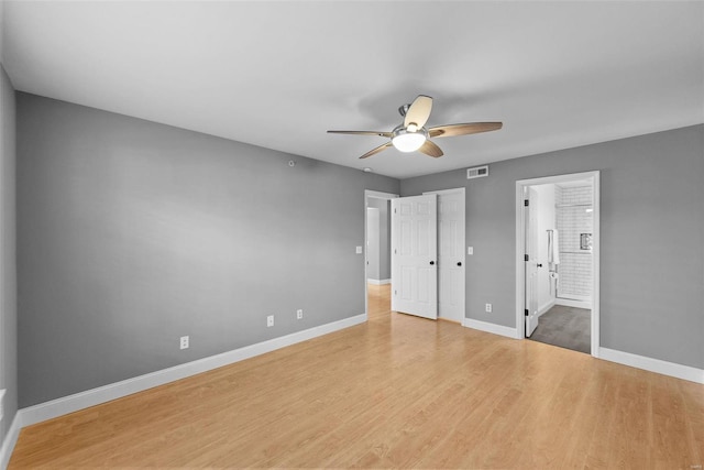 unfurnished bedroom featuring connected bathroom, ceiling fan, and light hardwood / wood-style floors