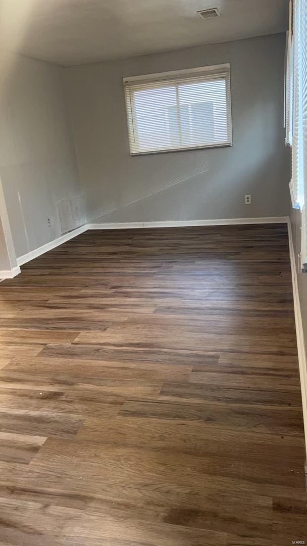 unfurnished room featuring dark wood-type flooring