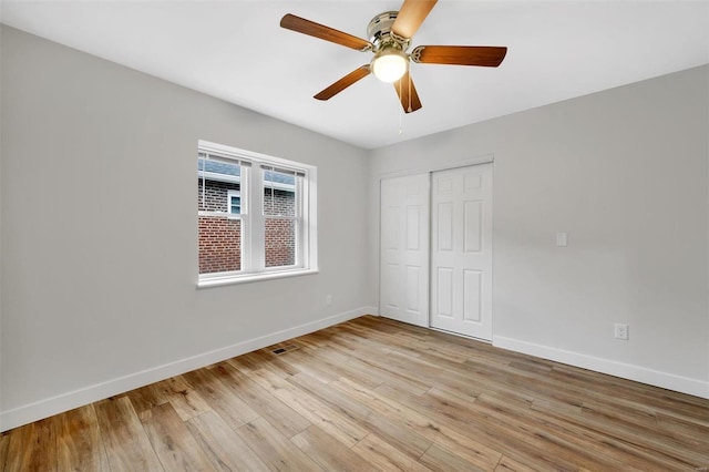 unfurnished bedroom with a closet, light hardwood / wood-style flooring, and ceiling fan