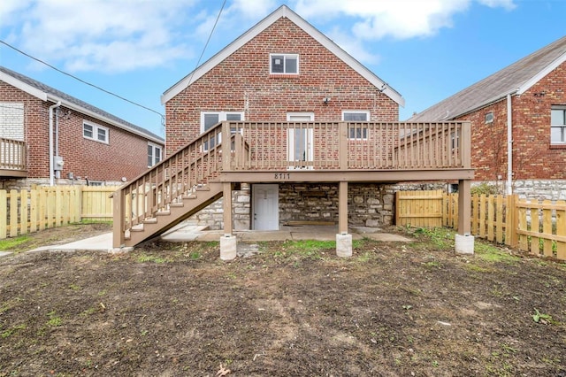 back of house with a wooden deck