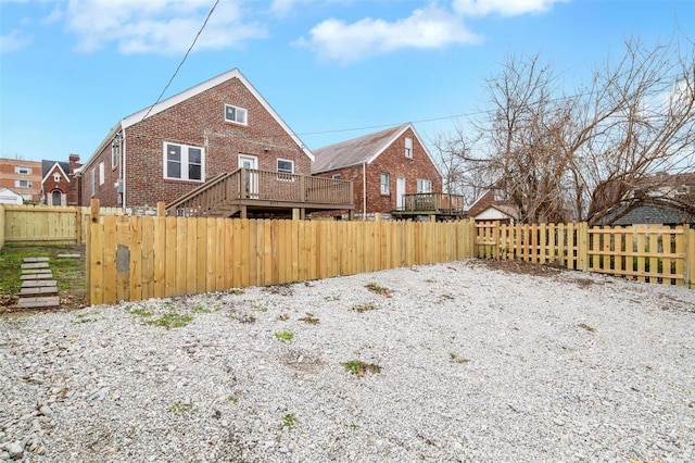 rear view of house featuring a wooden deck