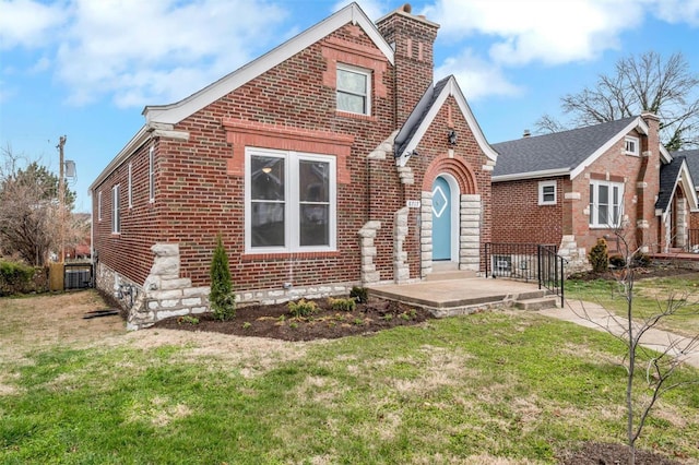 english style home featuring a front yard