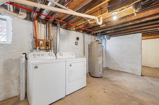 washroom with electric water heater and independent washer and dryer