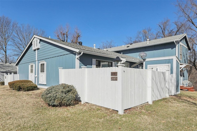 view of side of property featuring a yard and fence