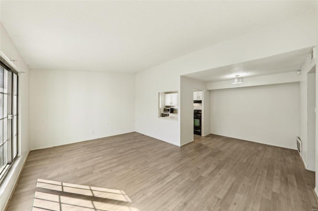 unfurnished room with visible vents and light wood-style flooring