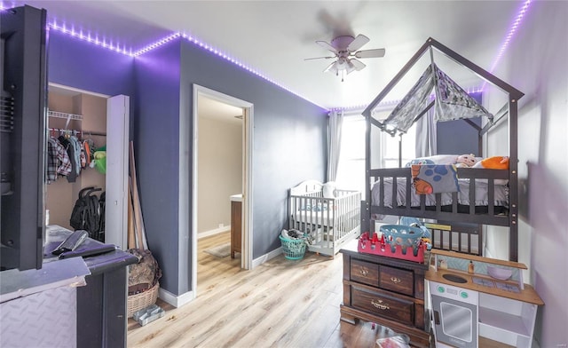 bedroom with a spacious closet, light hardwood / wood-style floors, and a closet