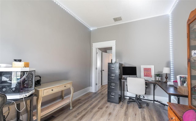 home office featuring hardwood / wood-style flooring and ornamental molding