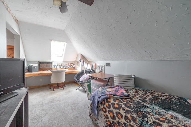 carpeted bedroom with ceiling fan, lofted ceiling, and a textured ceiling